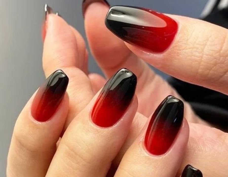 Glossy red nails with black tips