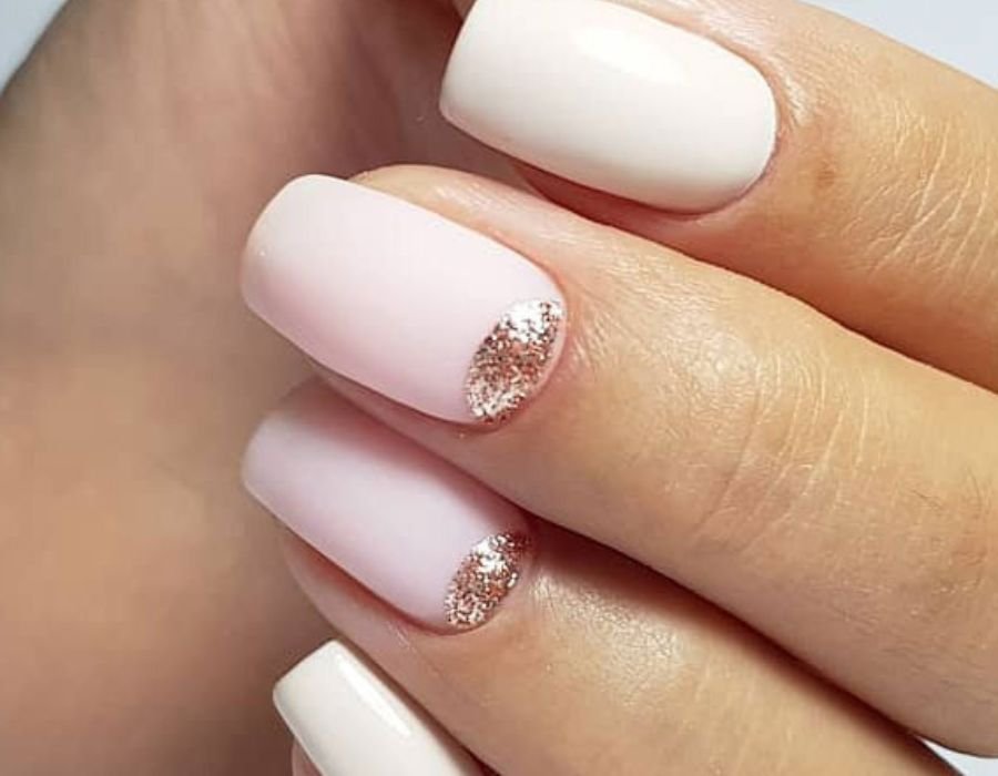 Crescent moon nails on a pale pink base
