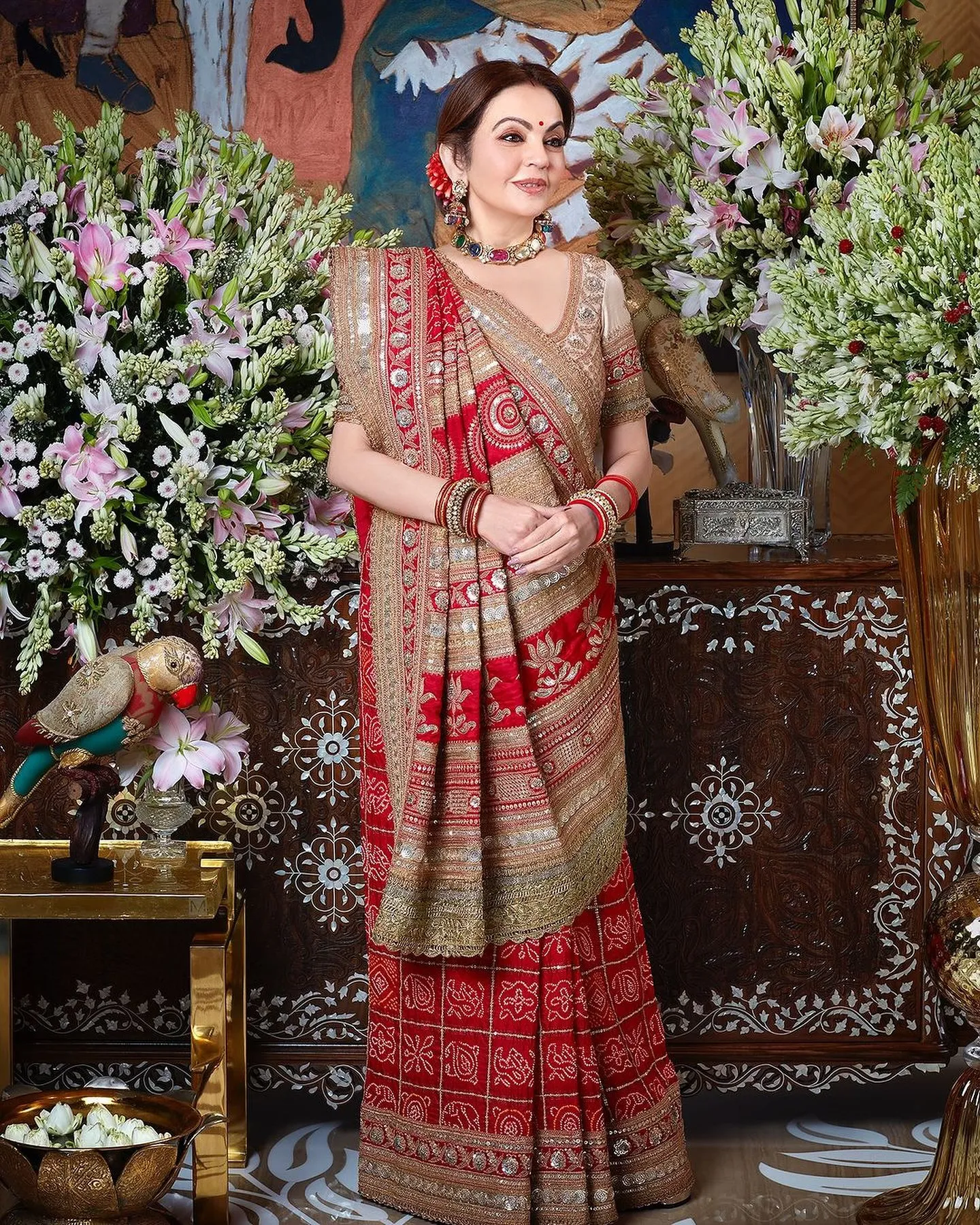 Woman in a red bandhani-style saree with gold embroidery, a karwa chauth look in saree